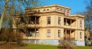 Ronneby, Sweden - February 26, 2016: The Italian villa is a heritage listed building from 1881, built to accommodate rich guests and their servants during spa visits. Two unknown persons on balcony.